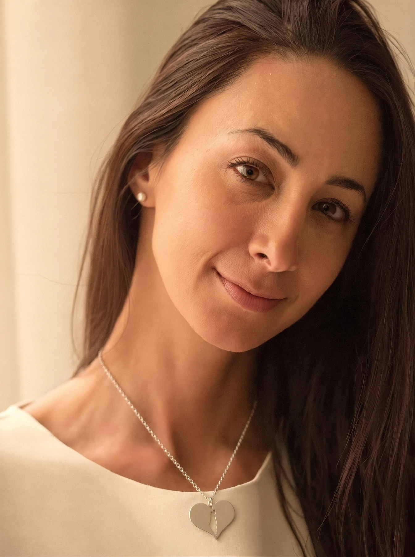 Portrait of Liad, wearing one of her silver heart pendants
