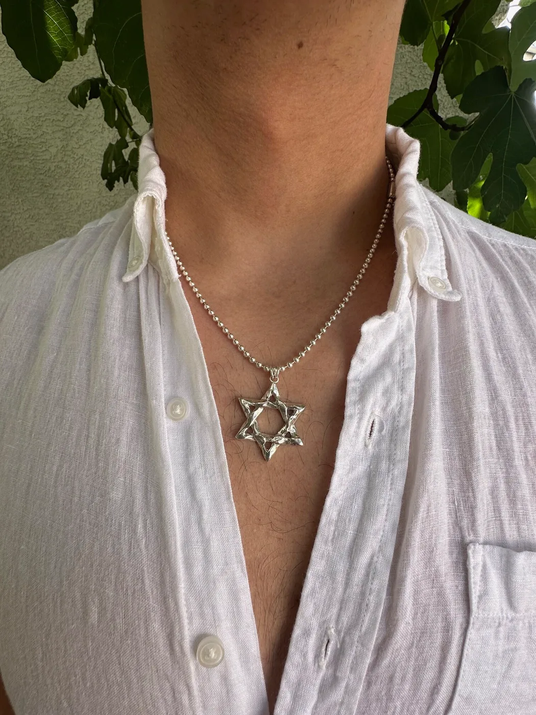 The same star worn on a man's chest over a white shirt