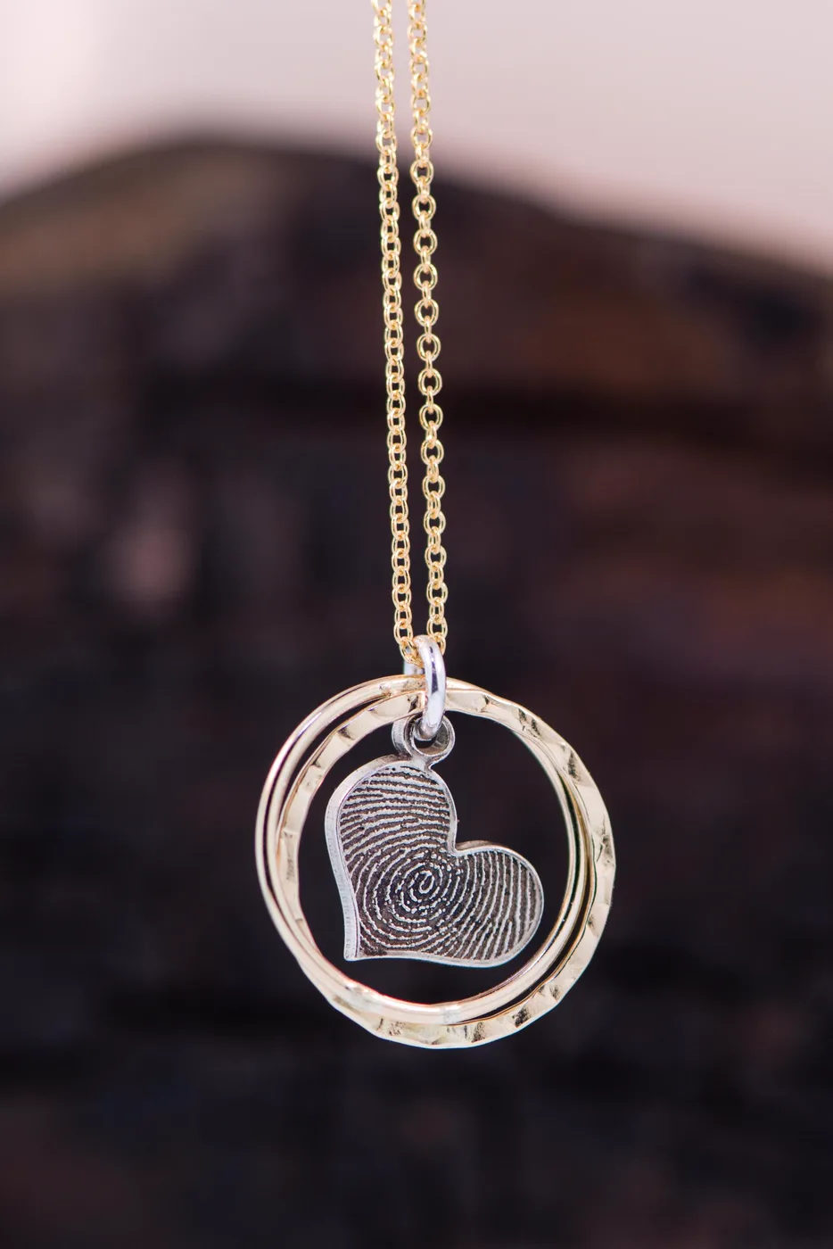 The halo pendant worn at the collarbone