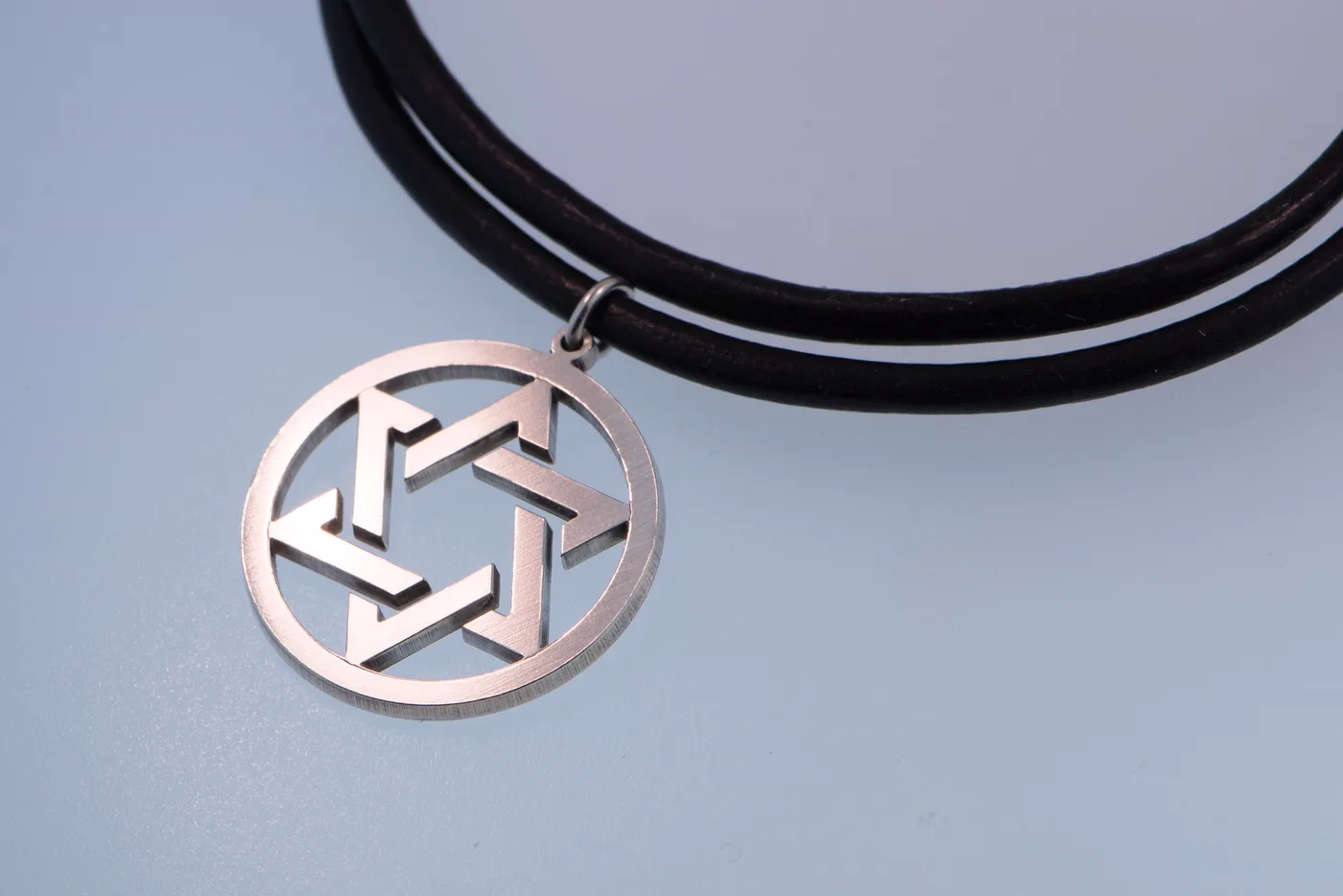 Round Star of David medallion in sterling silver on a black leather cord