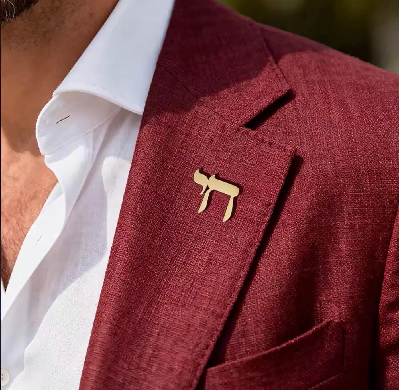 Chai lapel pin worn on a jacket