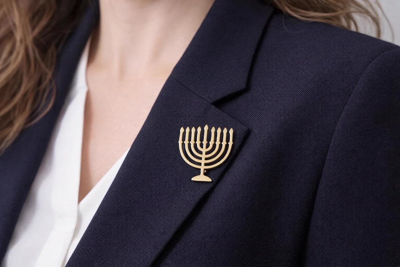 Menorah lapel pin worn on blazer