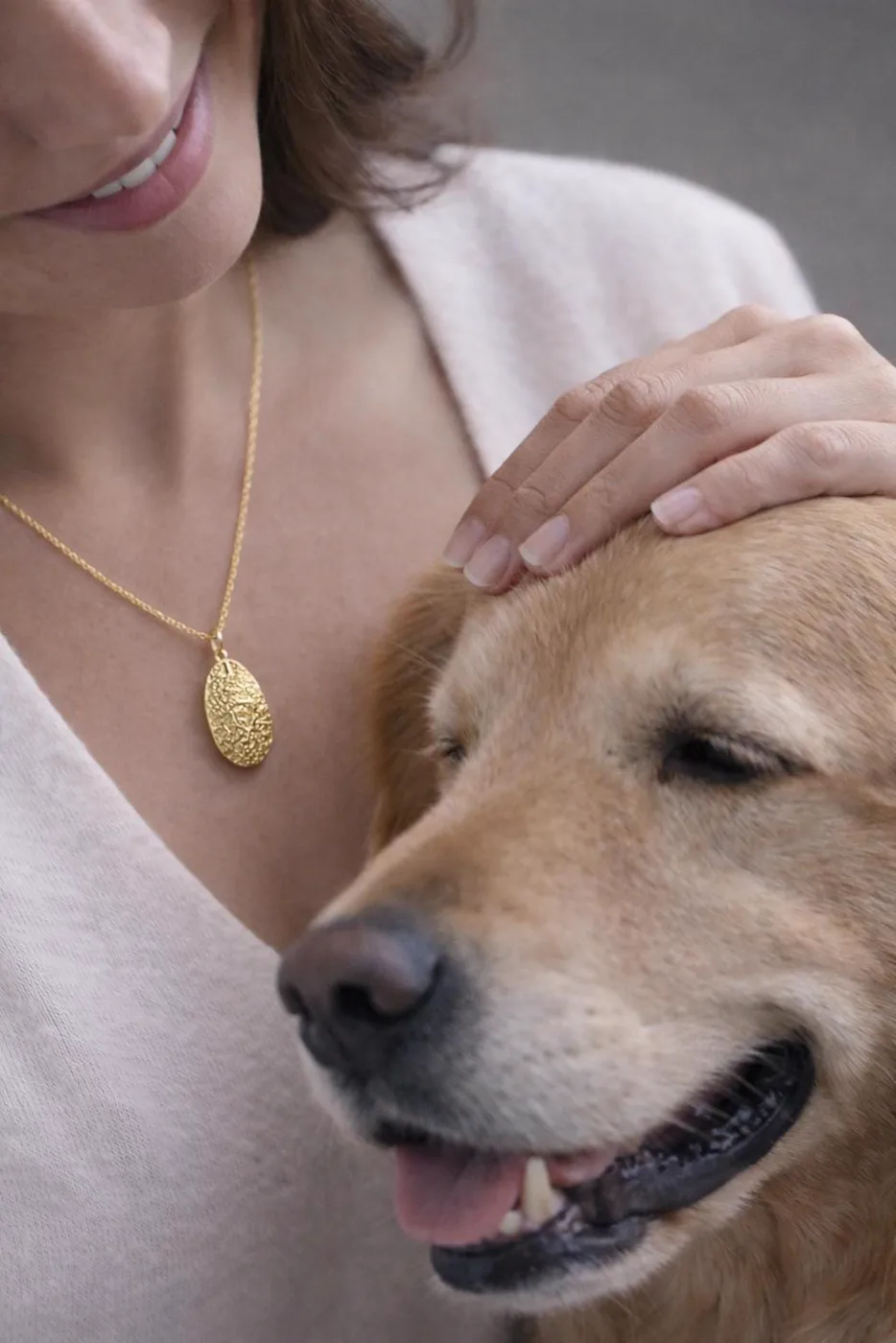 The nose print pendant worn, with the dog it was taken from